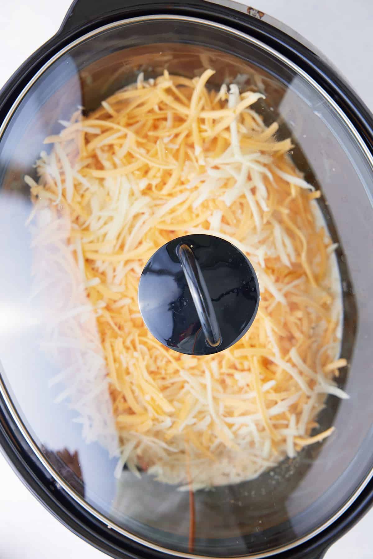 Slow cooker with lid placed on top