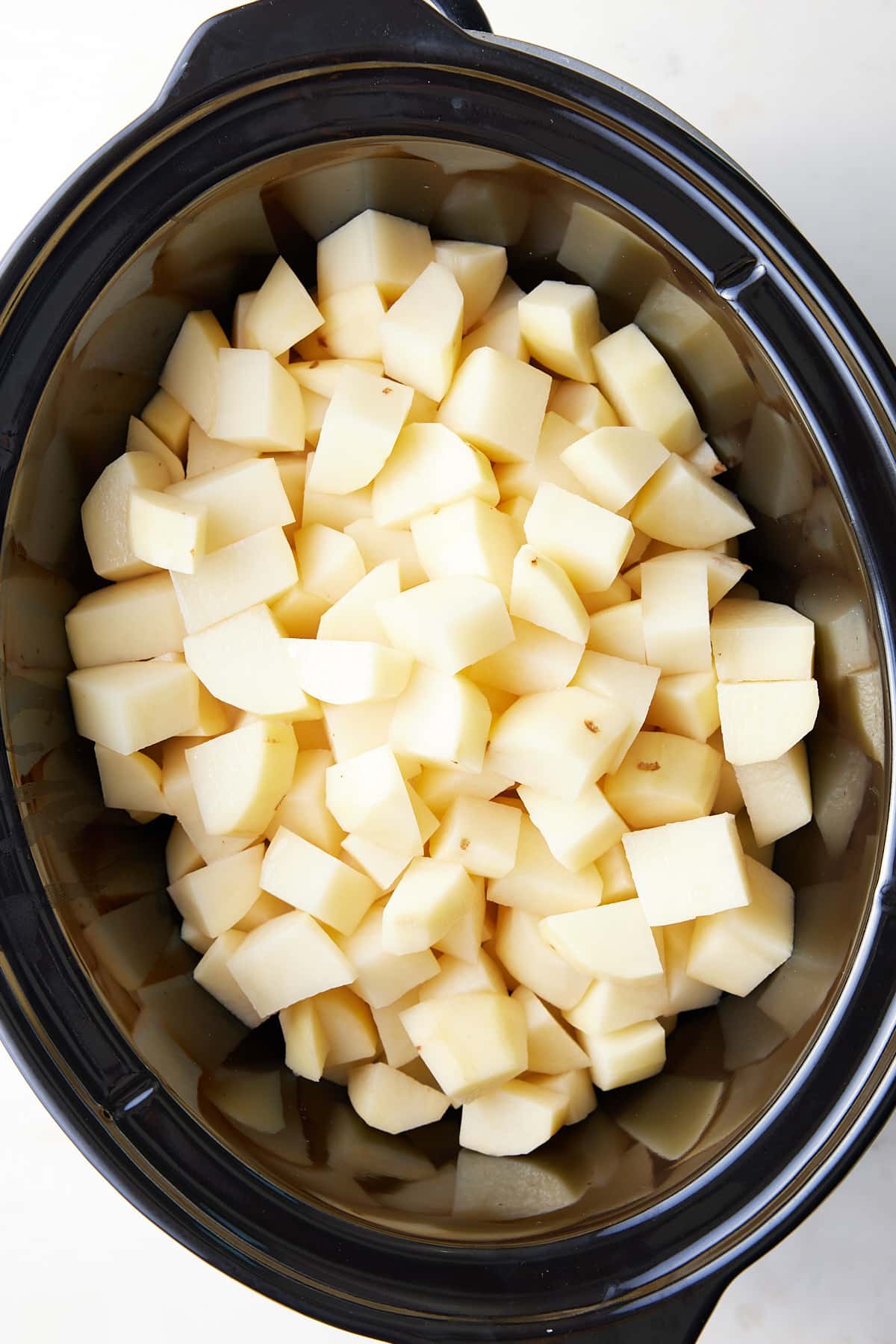cubed potatoes in a slow cooker