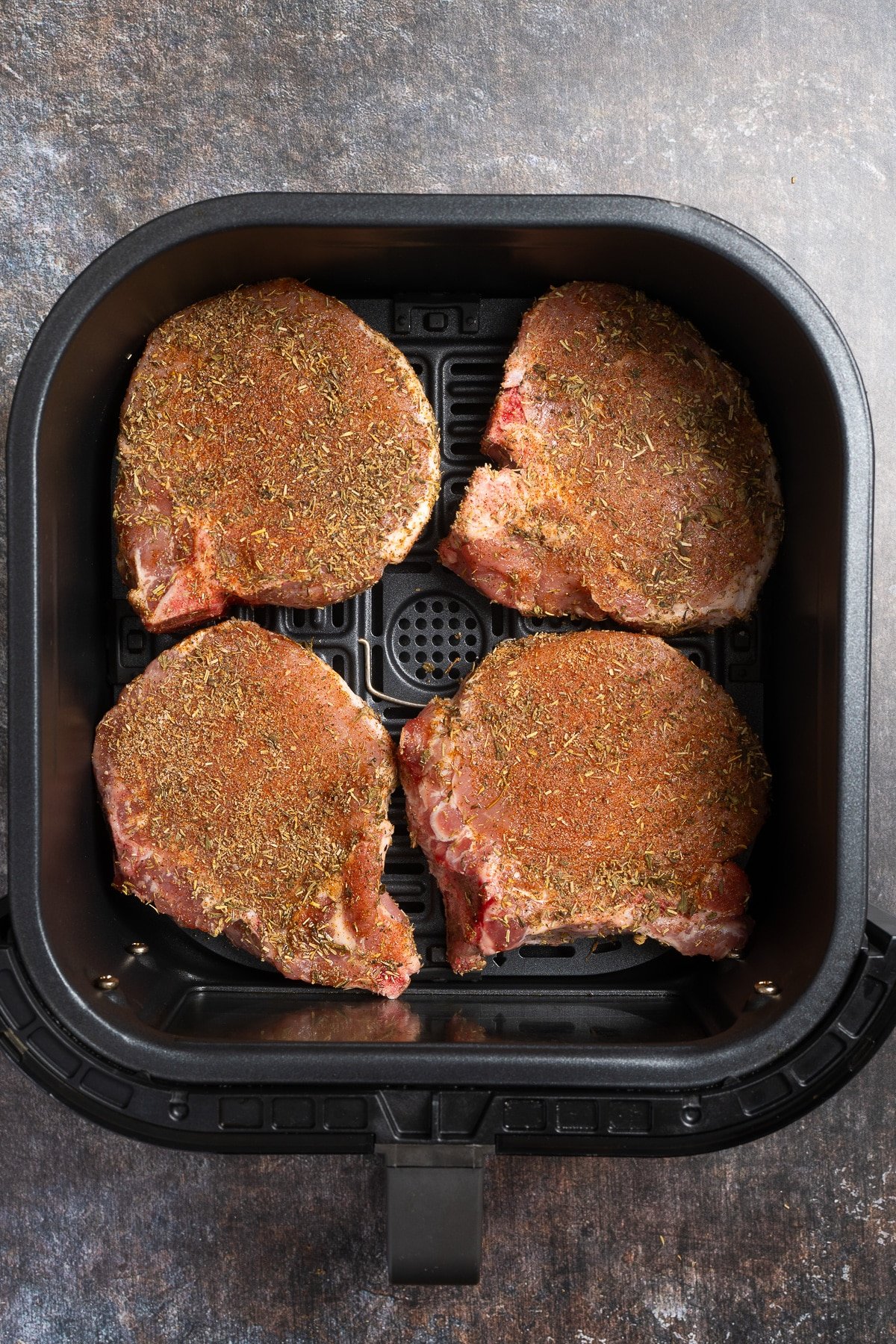 seasoned pork chops in air fryer basket