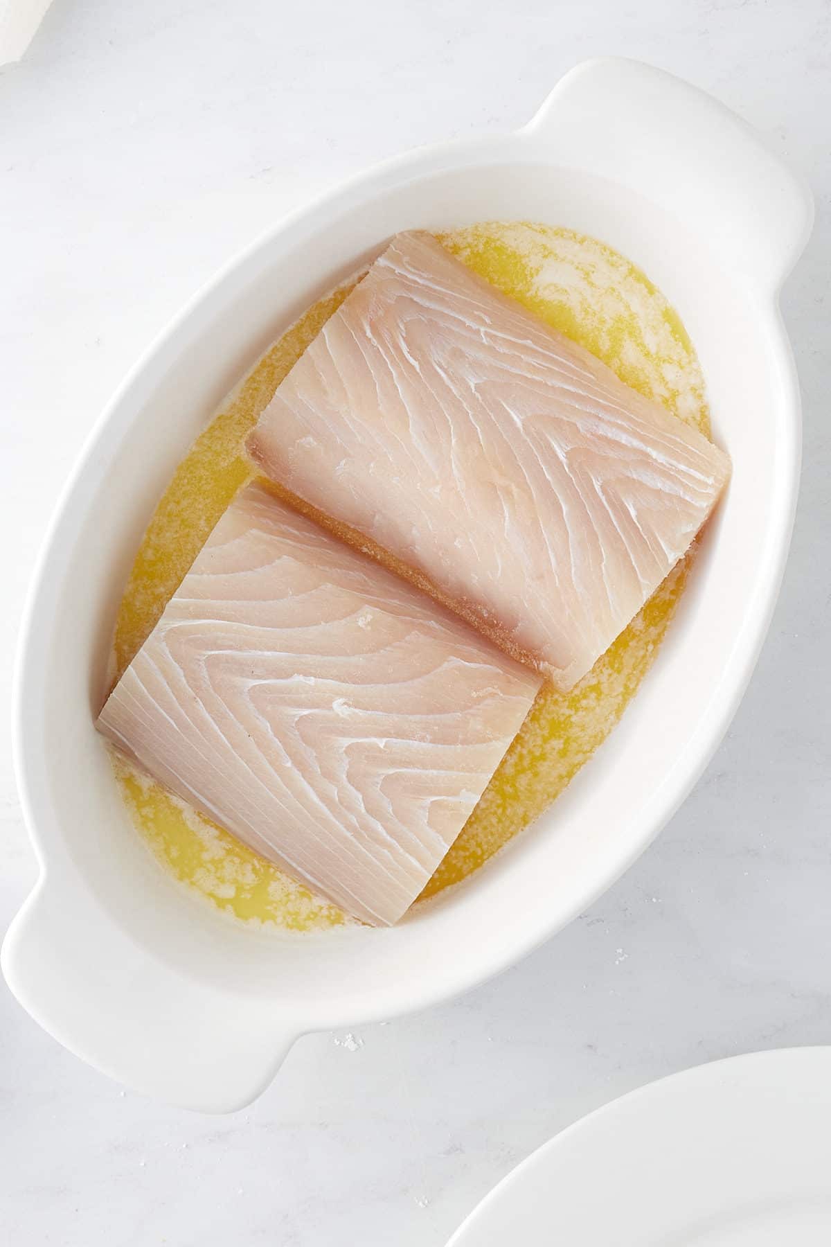 two mahi mahi fillets in a shallow dish