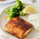 blackened mahi mahi on a plate with broccoli an mashed potatoes