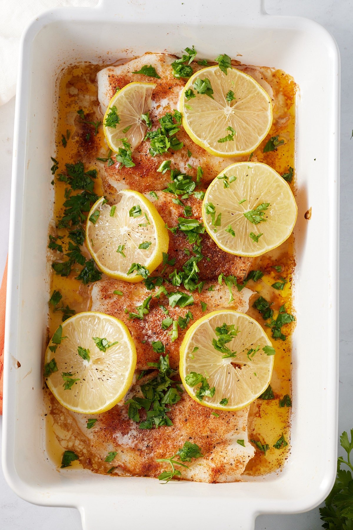oven baked cod covered in fresh parsley