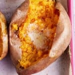 close up image of baked sweet potato topped with melted butter and salt and pepper