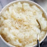 Bowl of mashed turnips with a spoon