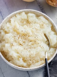 Bowl of mashed turnips with a spoon