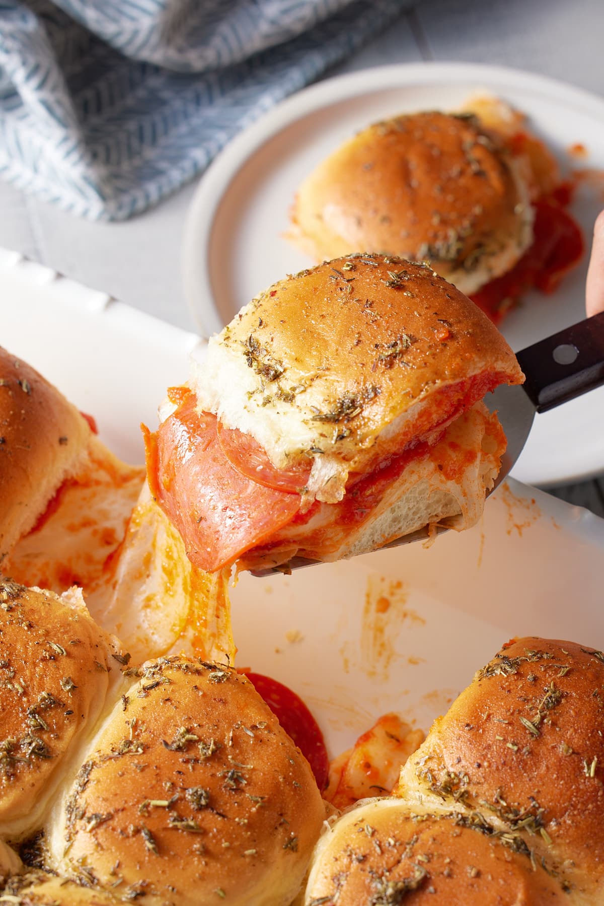portion of pizza sliders on a palate knife