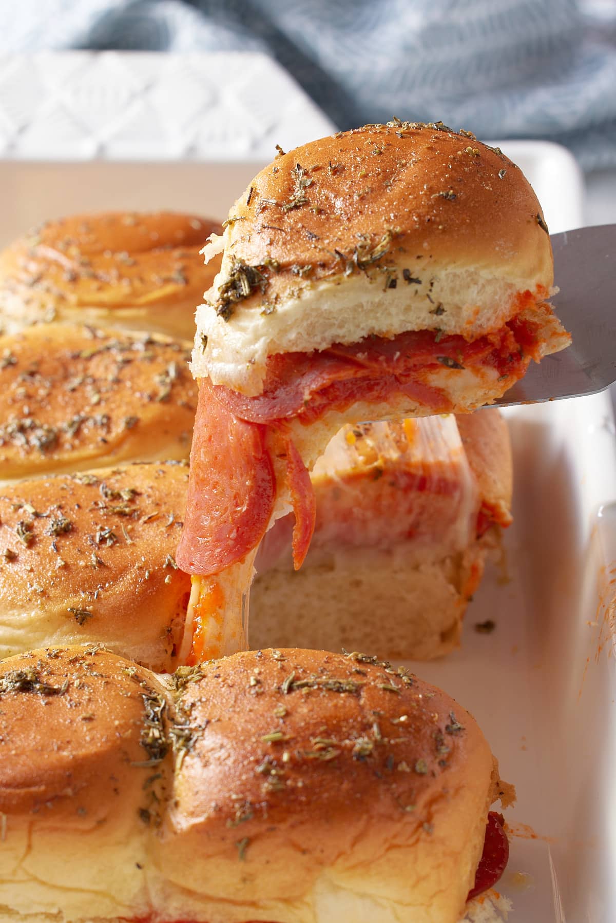 portion of pizza sliders on a palate knife