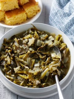 turnip greens in a bowl alongside corn bread