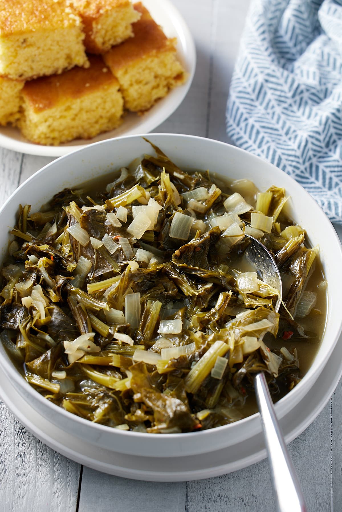 turnip greens in a bowl alongside corn bread