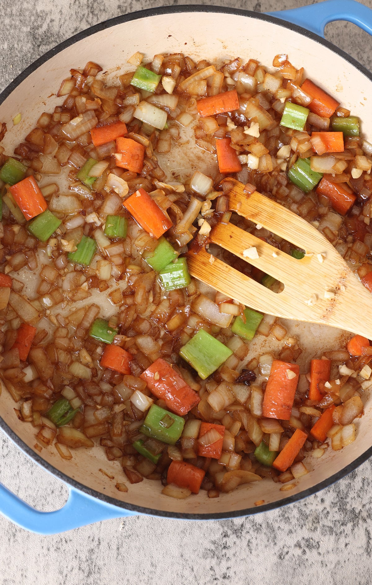 Dutch oven filled with sauteed onion, carrot, celery and garlic