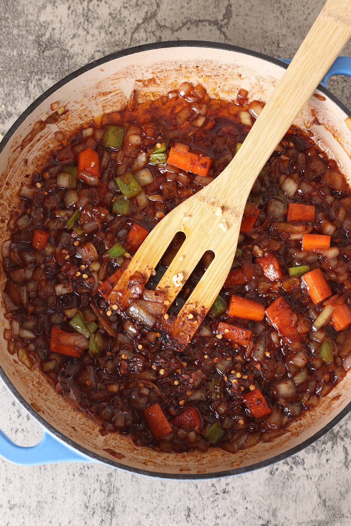 Dutch oven with sauteed vegetables with tomato paste and red pepper flakes stirred through