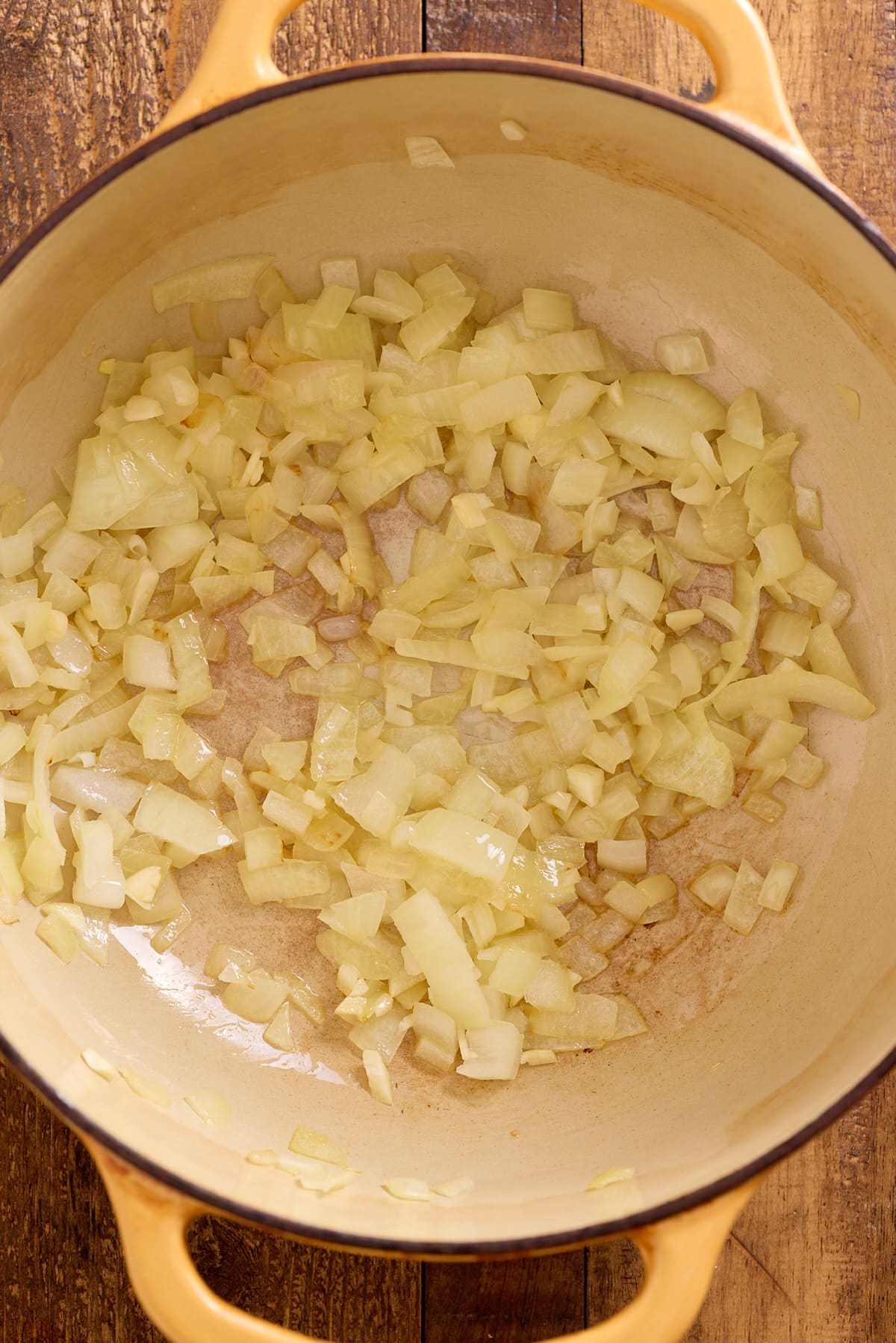 Dutch oven with sauteed onion and garlic in olive oil