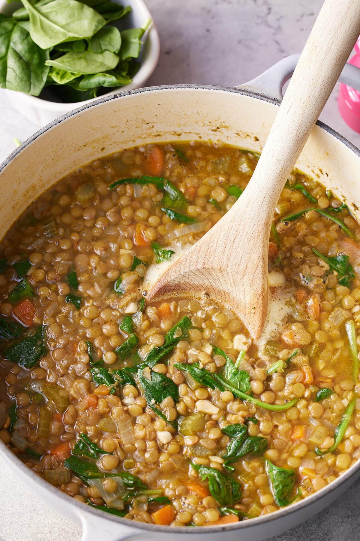 cooked lentil and spinach soup in a dutch oven