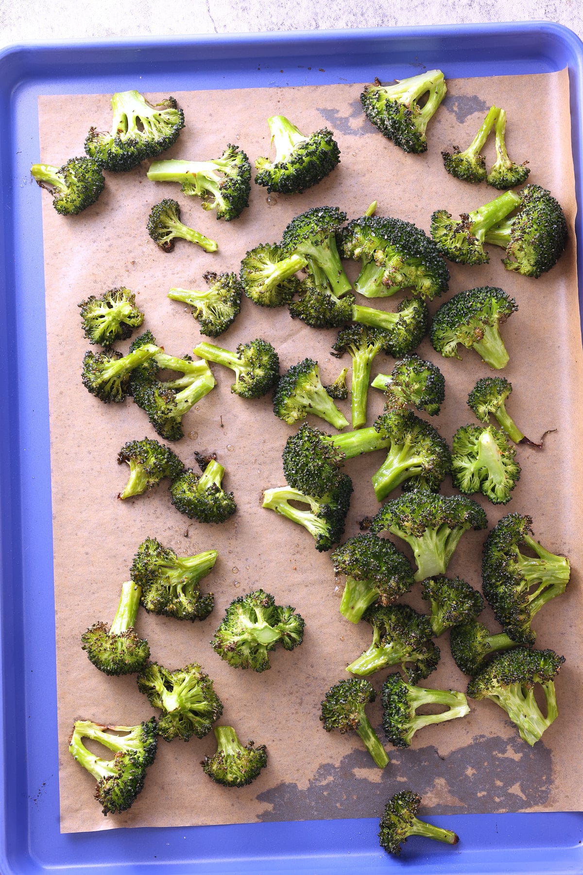 oven roasted broccoli florets on a baking sheet