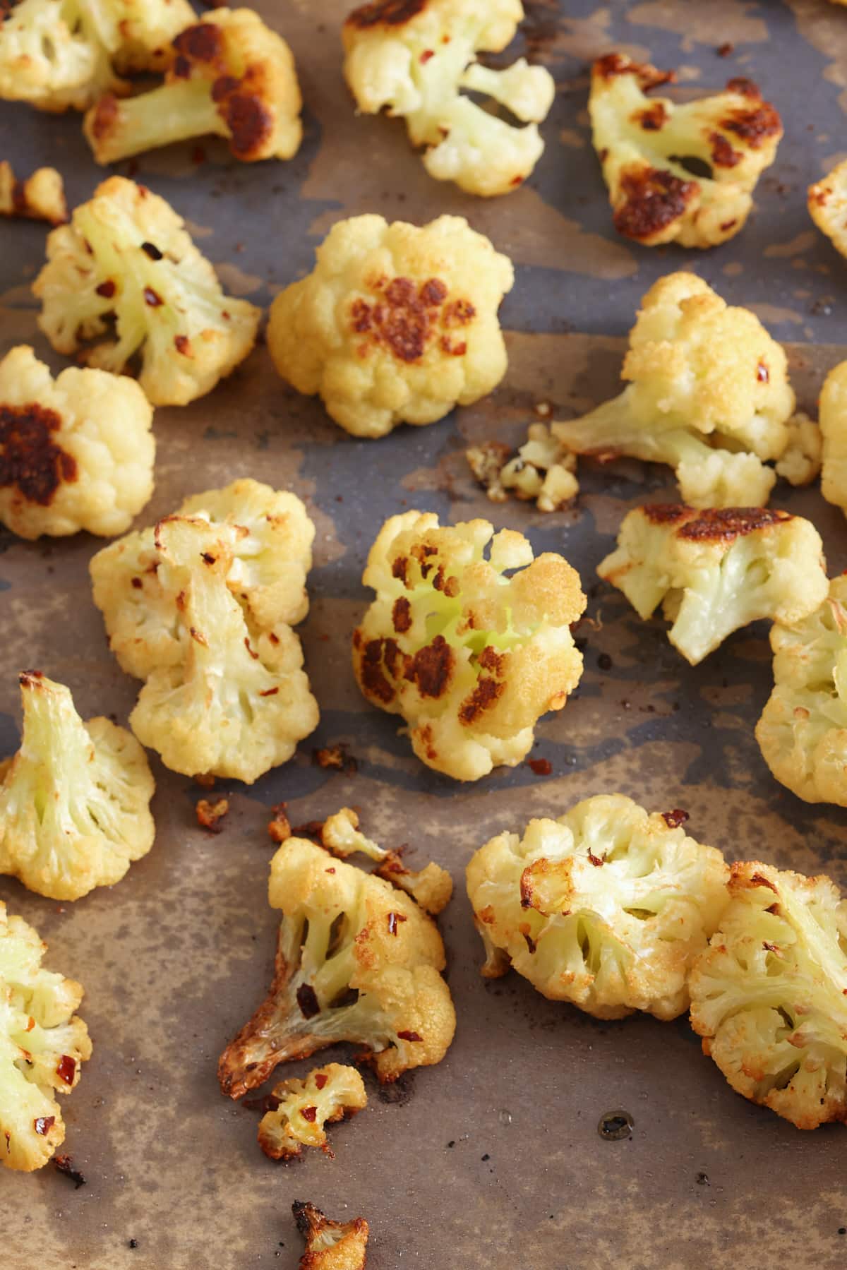 oven roasted cauliflower on a baking sheet.