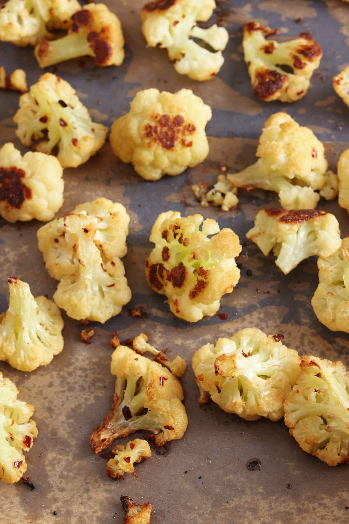 oven roasted cauliflower on a baking sheet. 