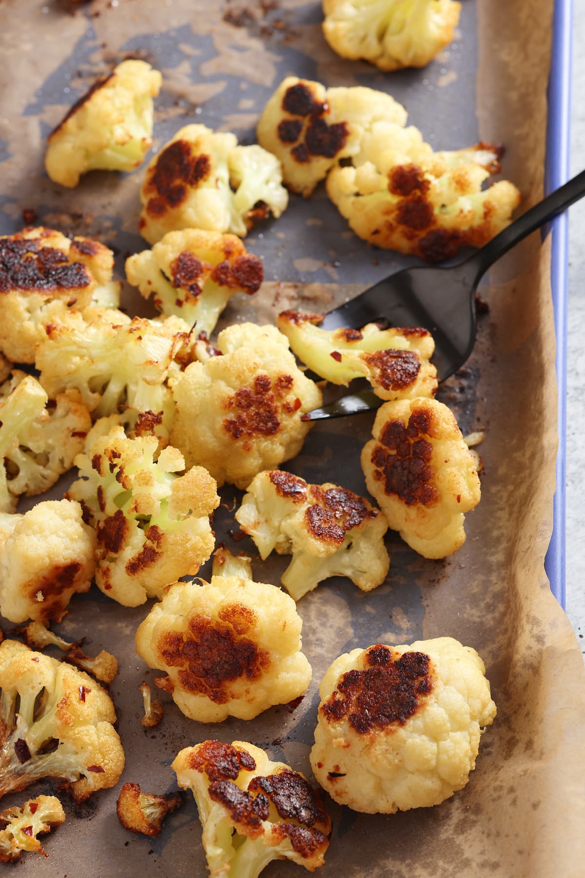 oven roasted cauliflower still on the baking sheet.