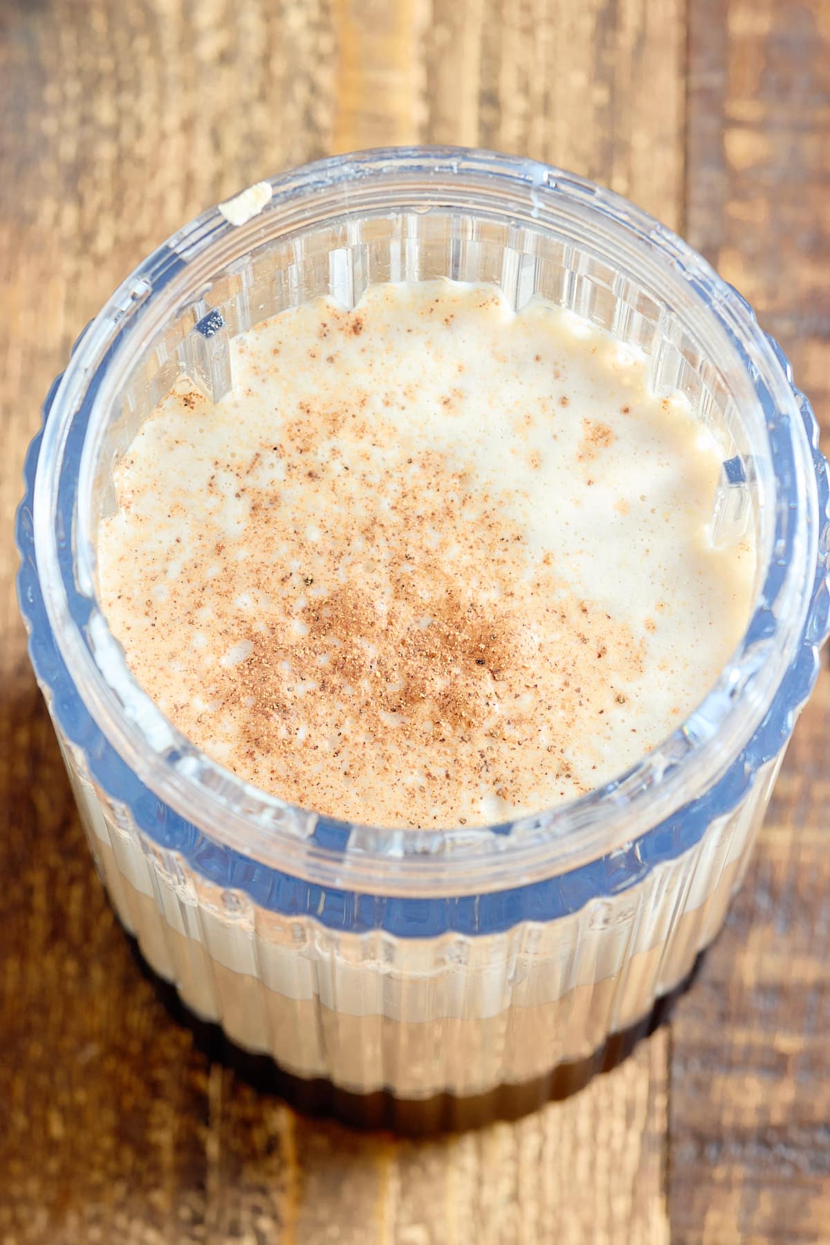 A glass of Jamaican Guinness punch topped with ground nutmeg