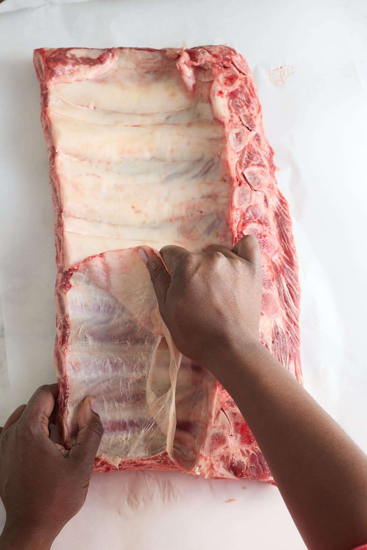 rack of beef ribs with the membrane being removed