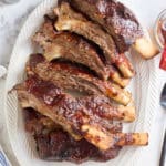 white serving platter filled with oven baked beef ribs