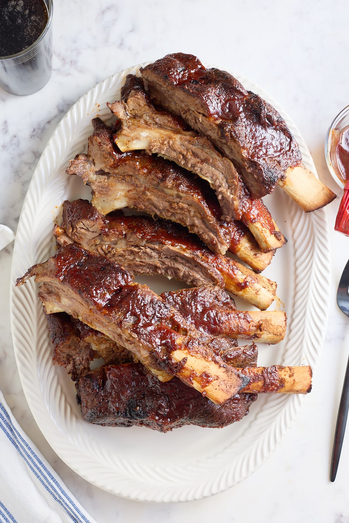 white serving platter filled with oven baked beef ribs