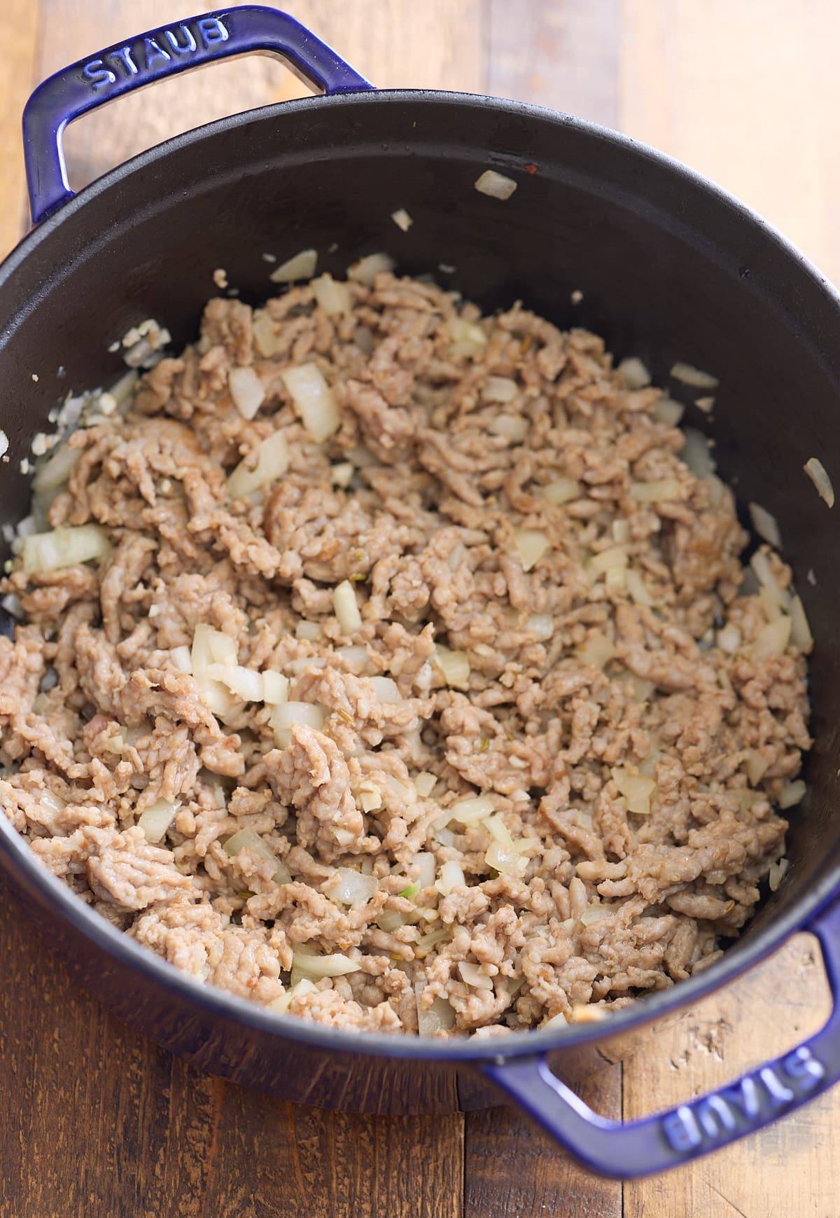 Cooked sausage and onions in the dutch oven.