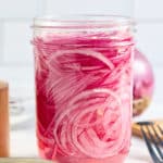 a jar filled with quick pickled red onions