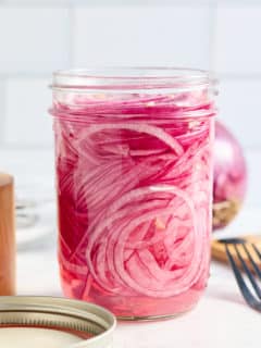 a jar filled with quick pickled red onions