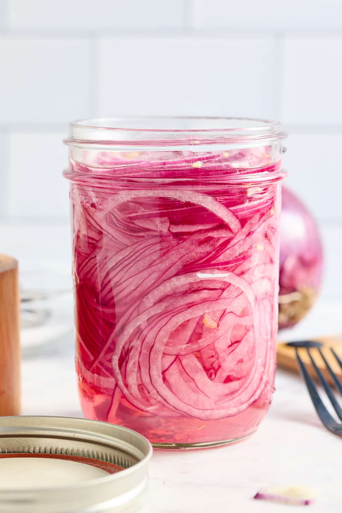 a jar filled with quick pickled red onions
