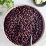 Large serving bowl of freshly cooked black beans.