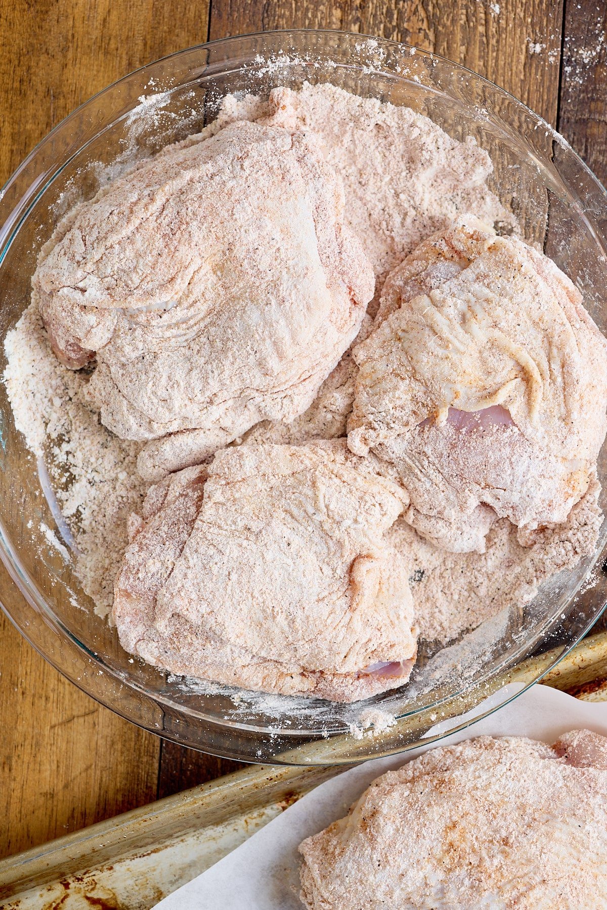 Bone-in skin-on chicken thighs coated in seasoned flour