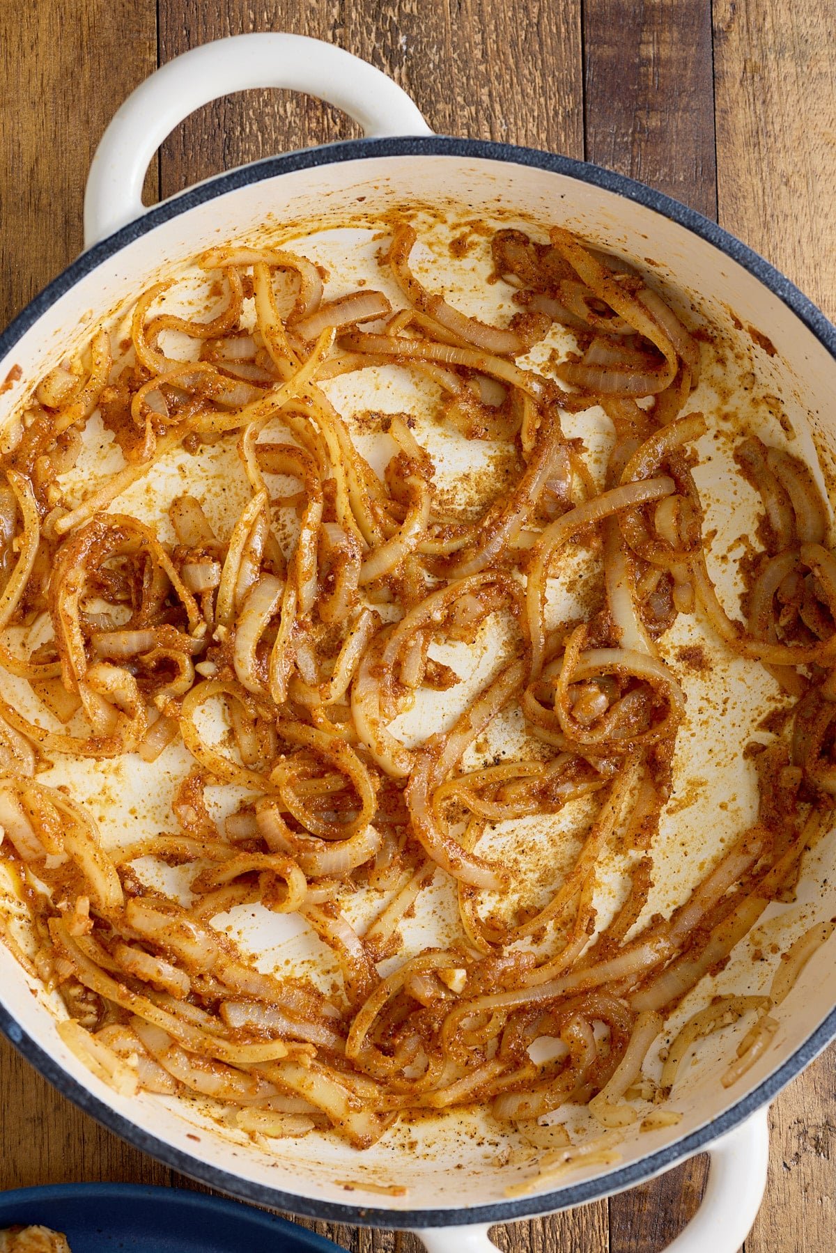 Dutch oven with sauteed onions in a seasoned flour