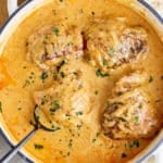 Dutch oven filled with smothered chicken thighs