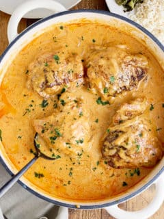 Dutch oven filled with smothered chicken thighs