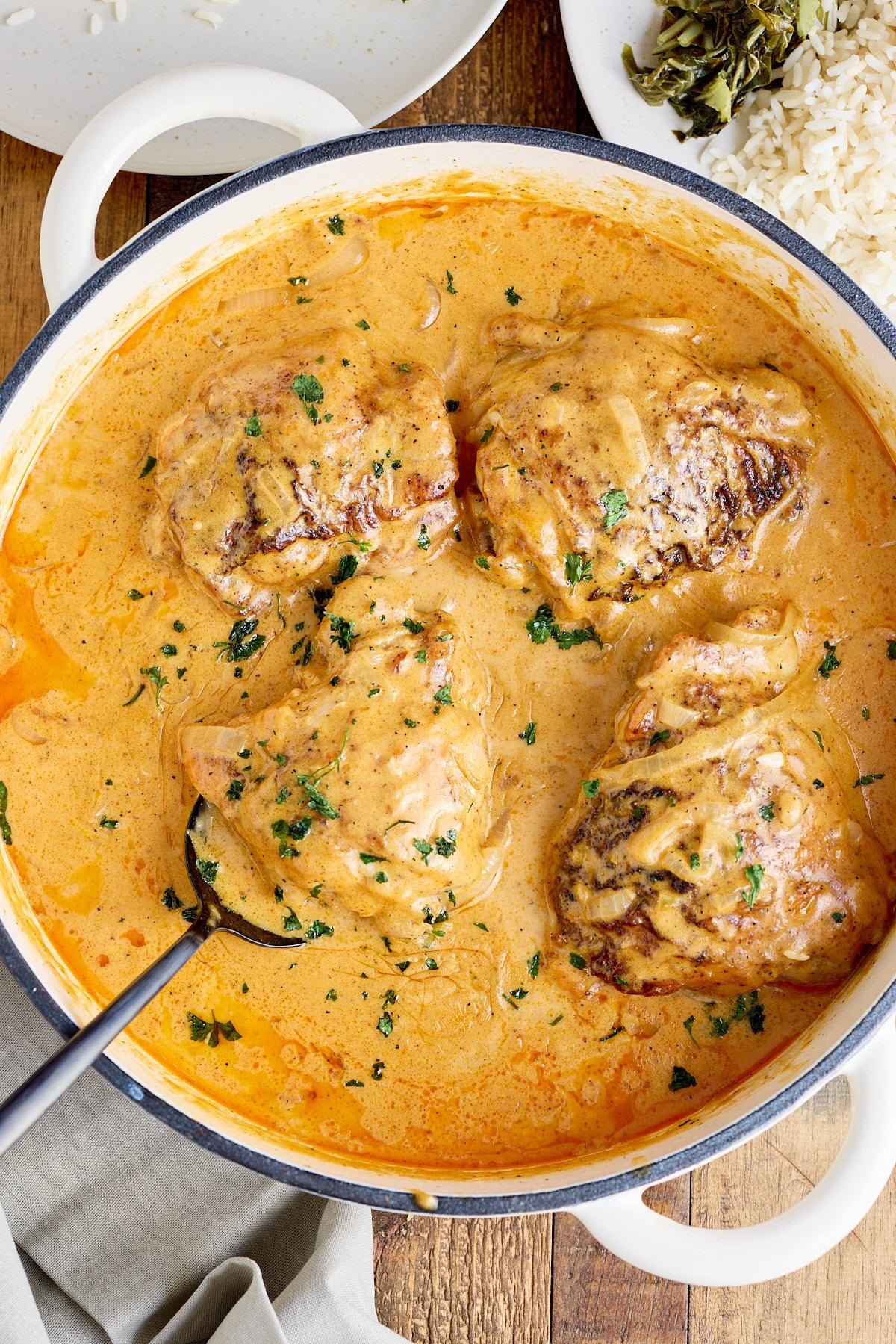 Dutch oven filled with smothered chicken thighs