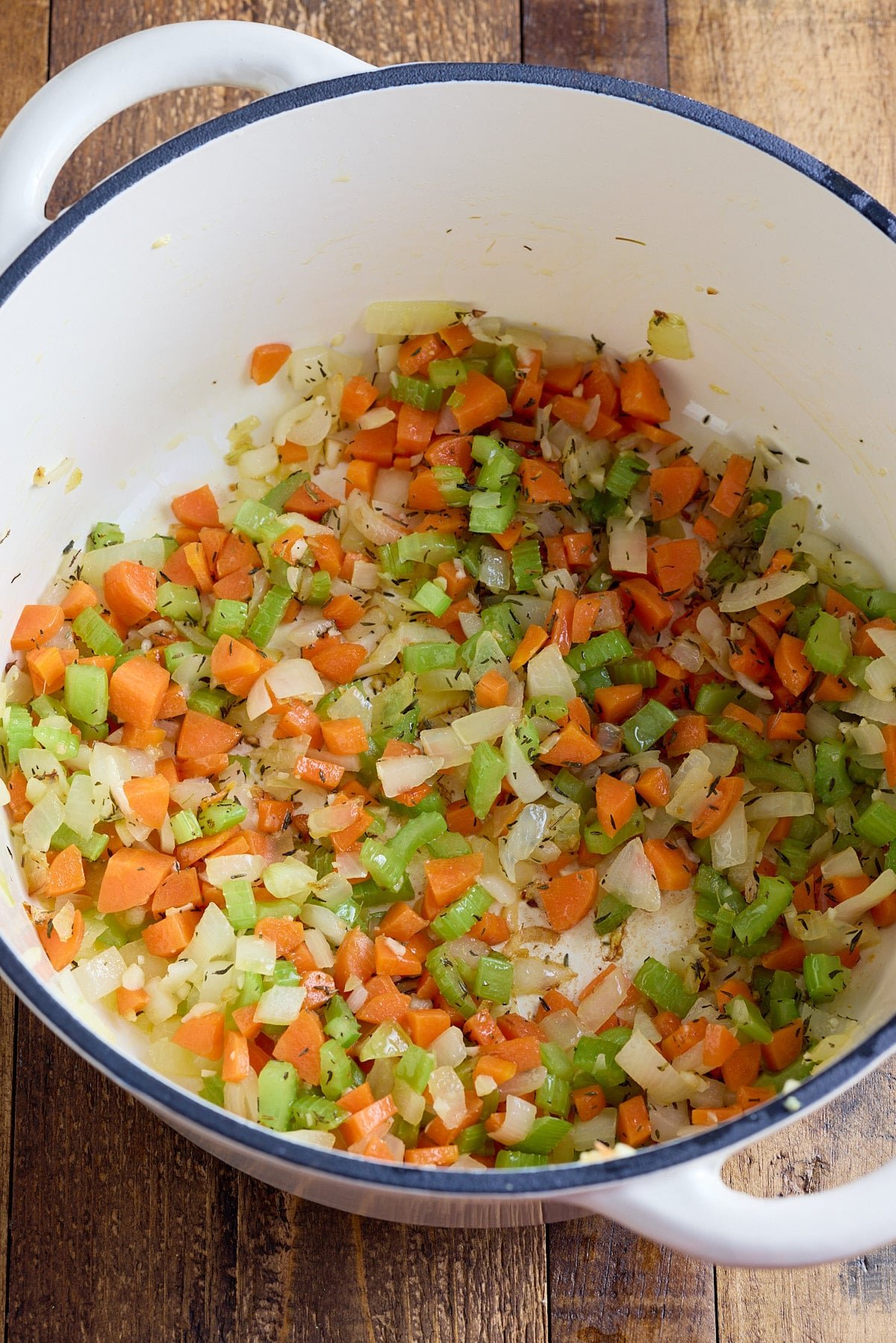 Sautéing vegetables in a pot.