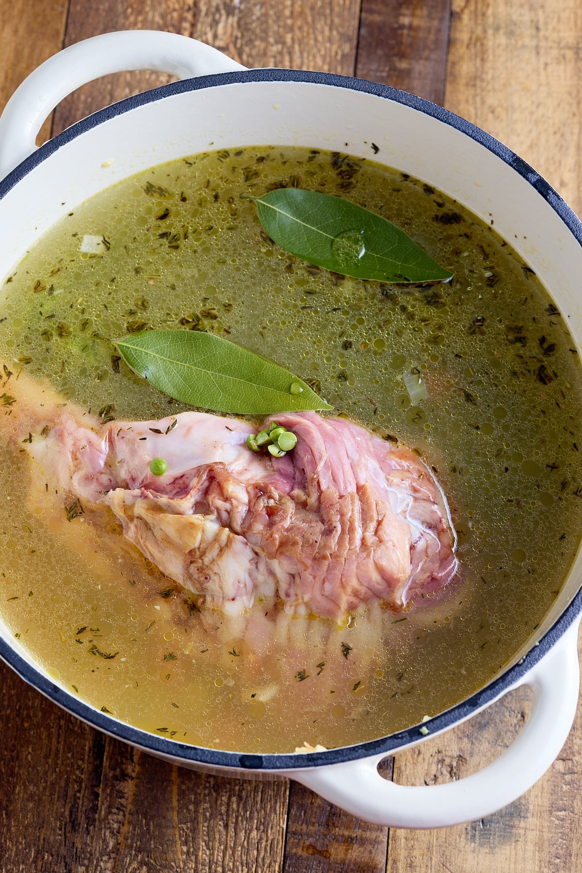 The soup ingredients including the ham bone added to the pot.