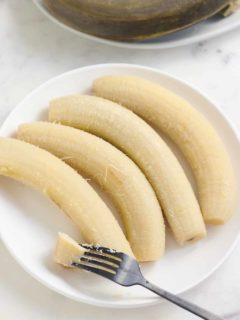 boiled green banana on white plate