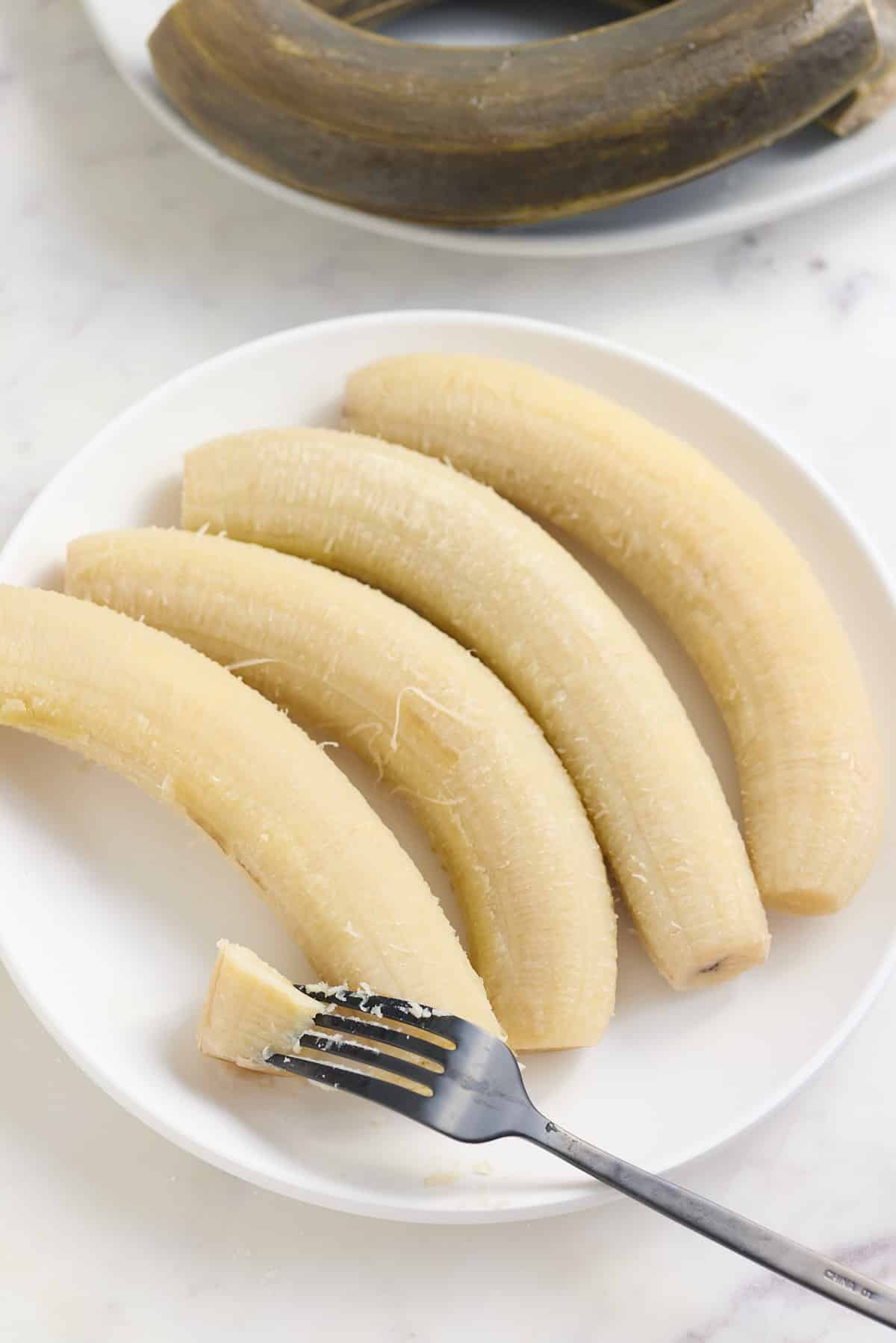 boiled green banana on white plate