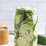 glass mason jar filled with cucumber and sweet onion refrigerator pickles