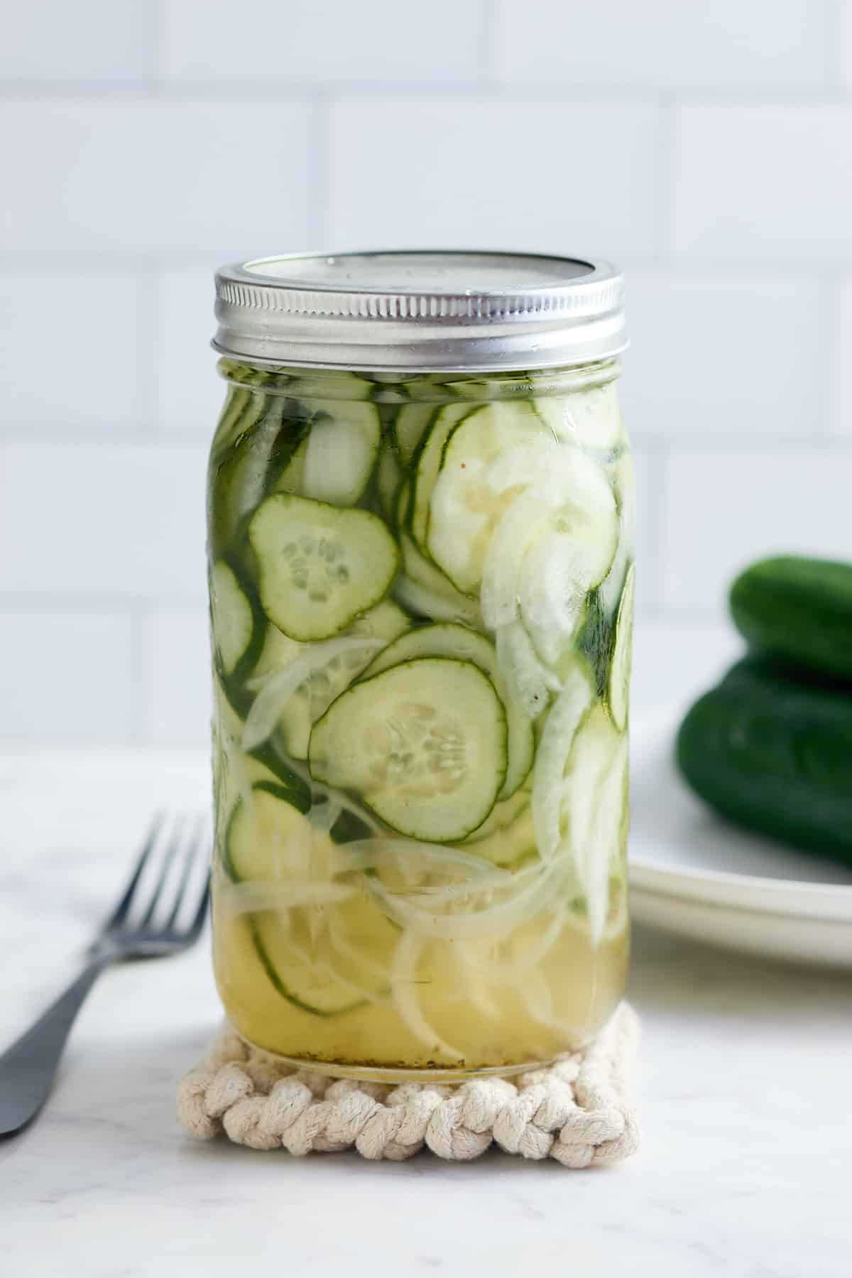 Mason jar filled with cucumber and sweet onion refrigerator pickles