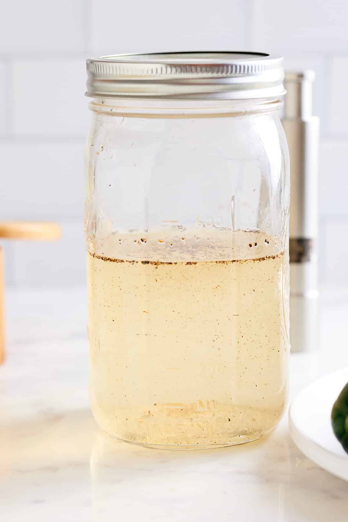 a mason jar filled with pickling liquid