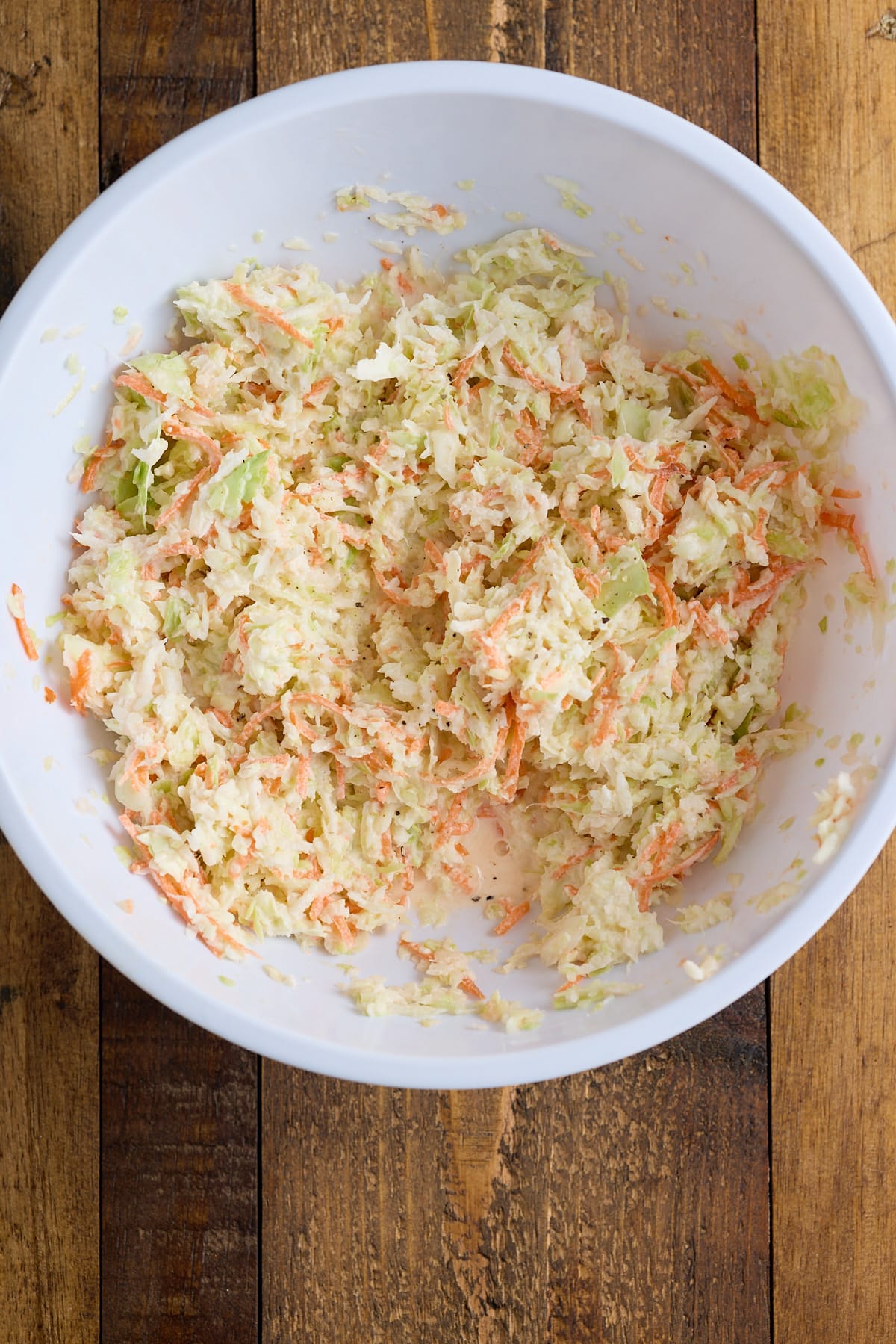 Coleslaw recipe mixed up in a mixing bowl.