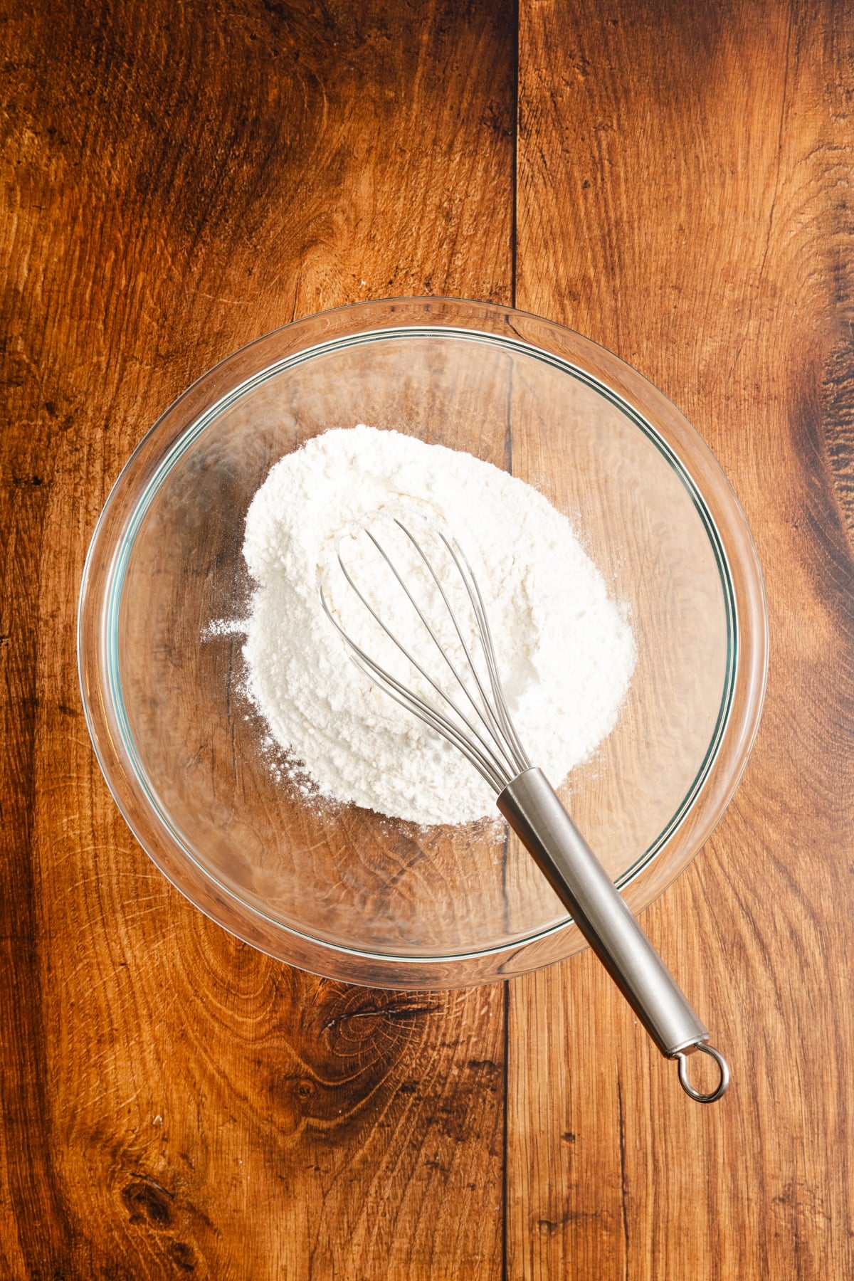 Dry ingredients in a bowl with a whisk.