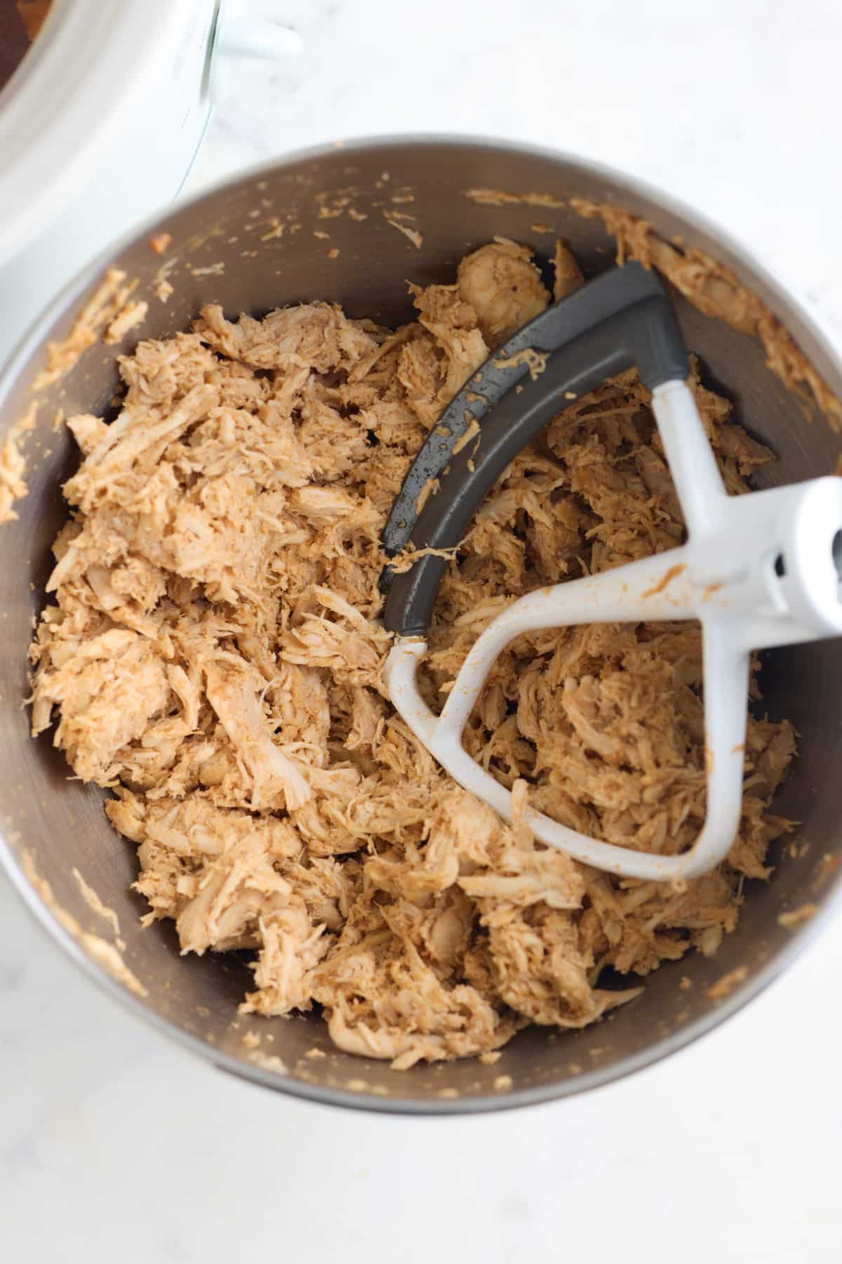 Shredding the chicken with a stand mixer.