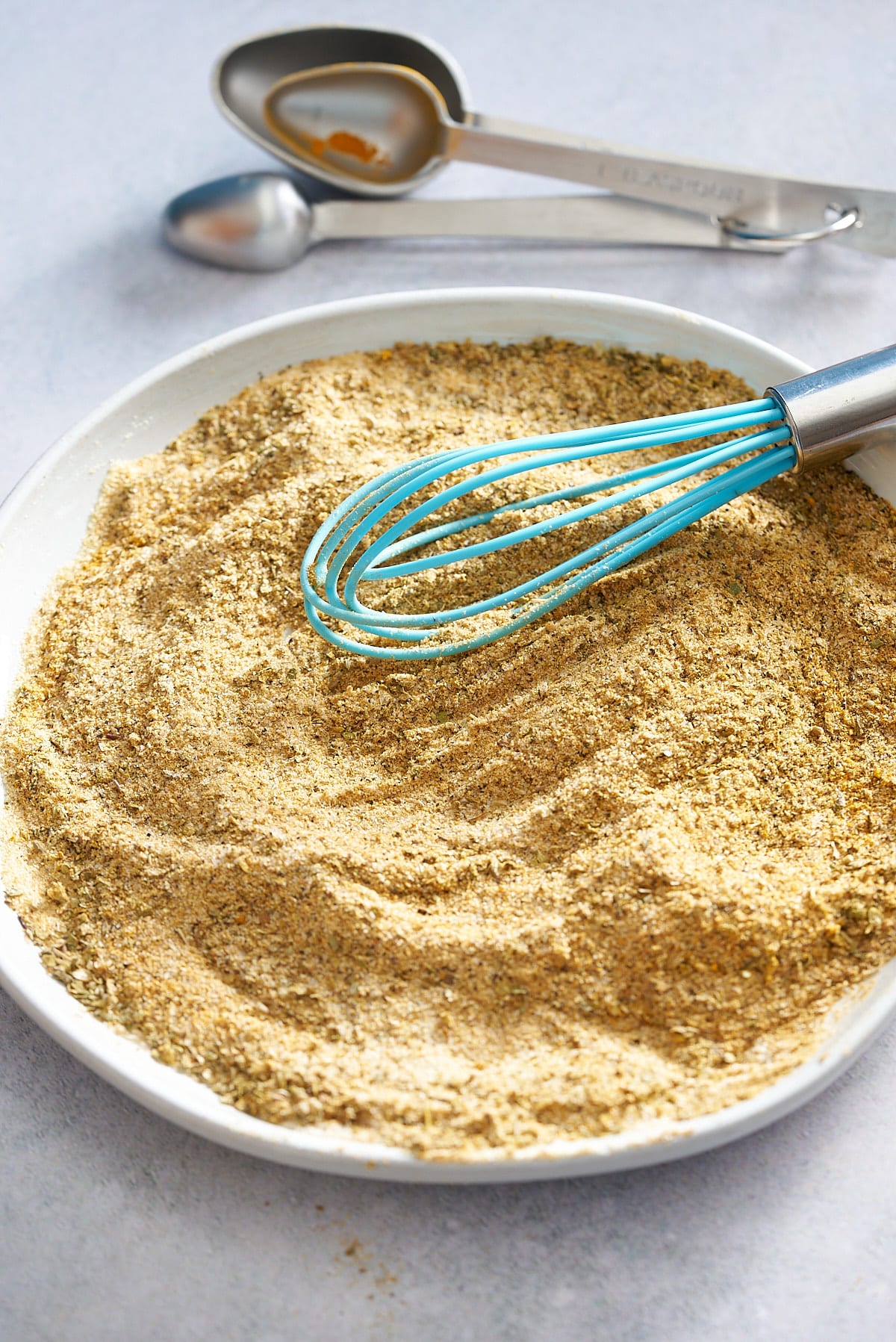 Whisking the spices together on a plate.