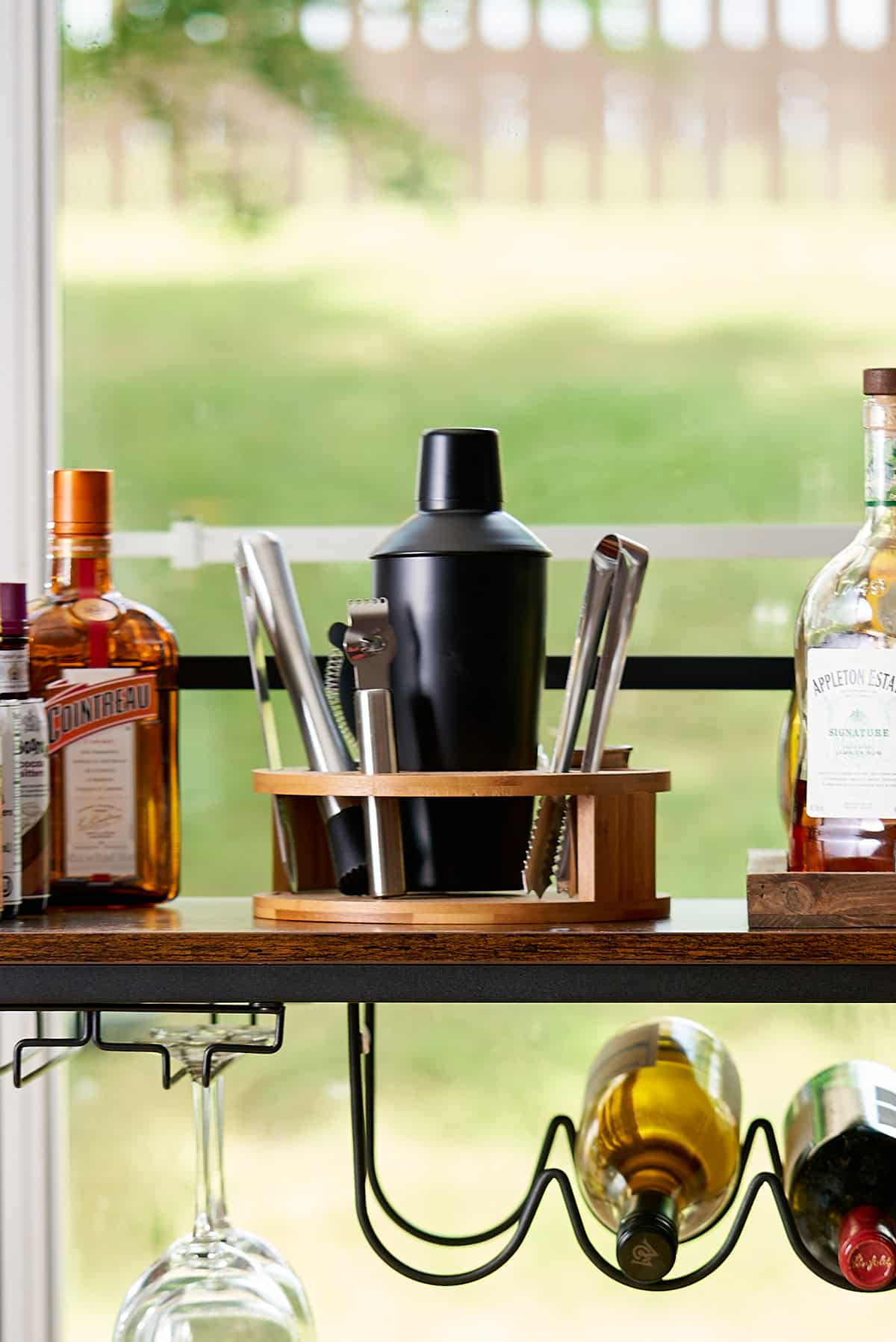 cocktail shaker and other bar tools on cart