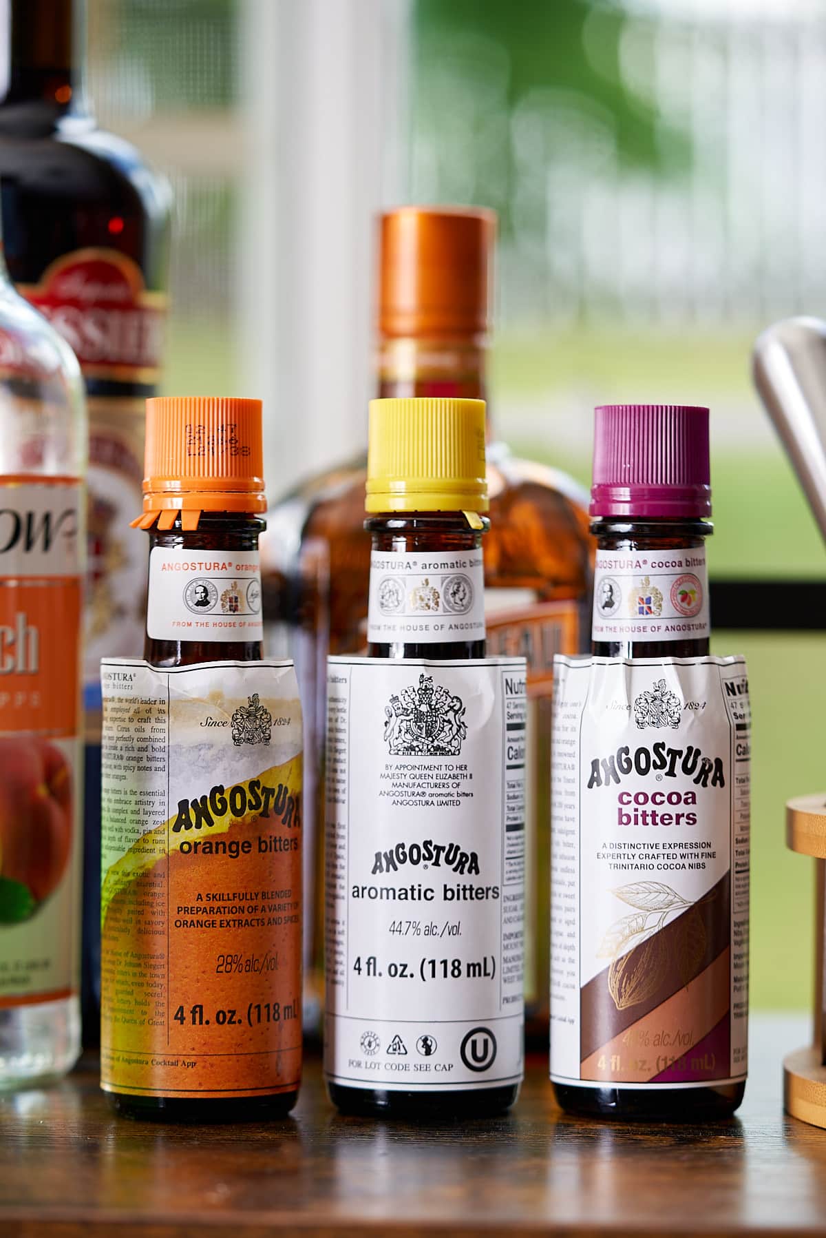 photo of bitters that are home bar essentials on bar cart
