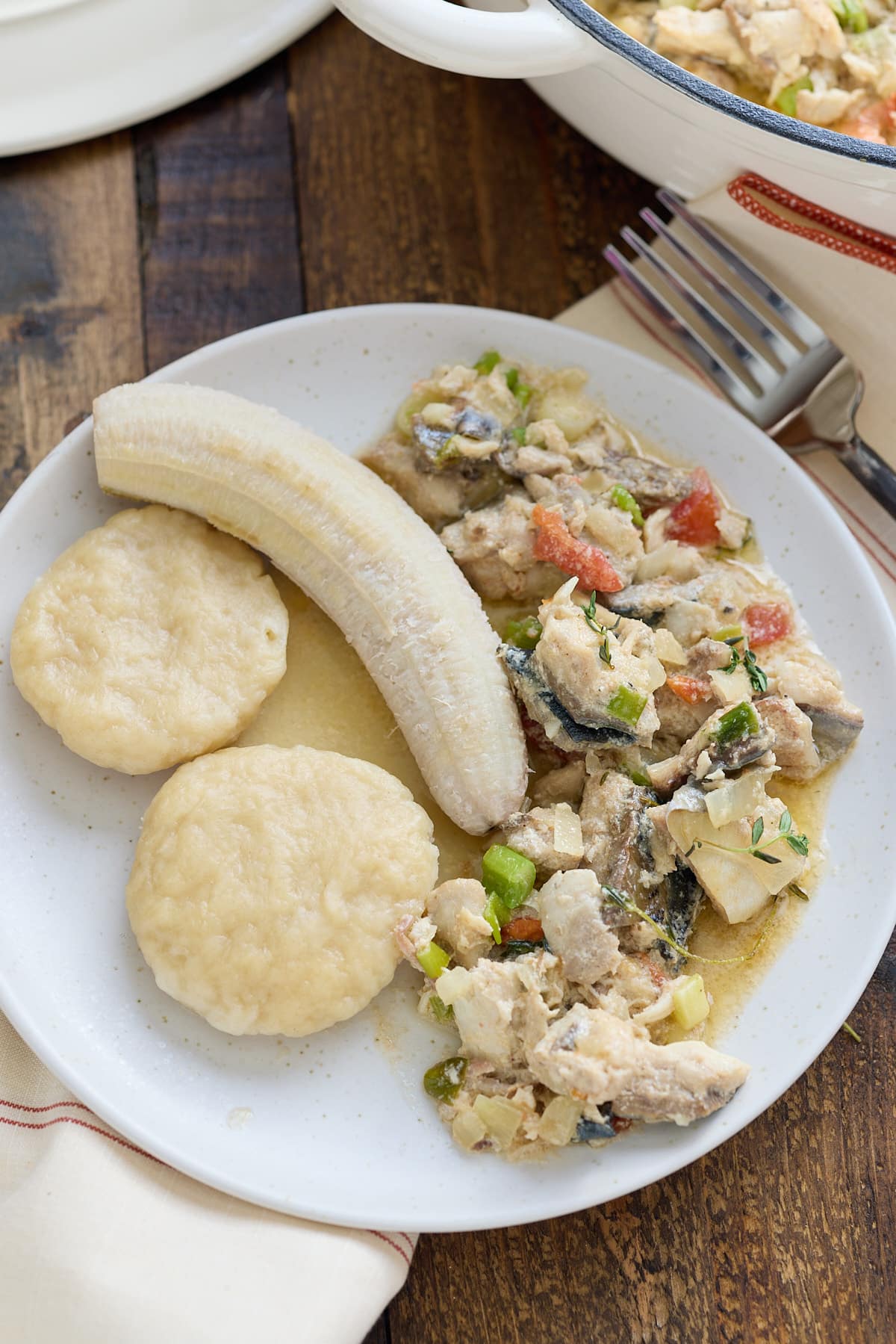 mackerel run down on plate with green banana and dumpling