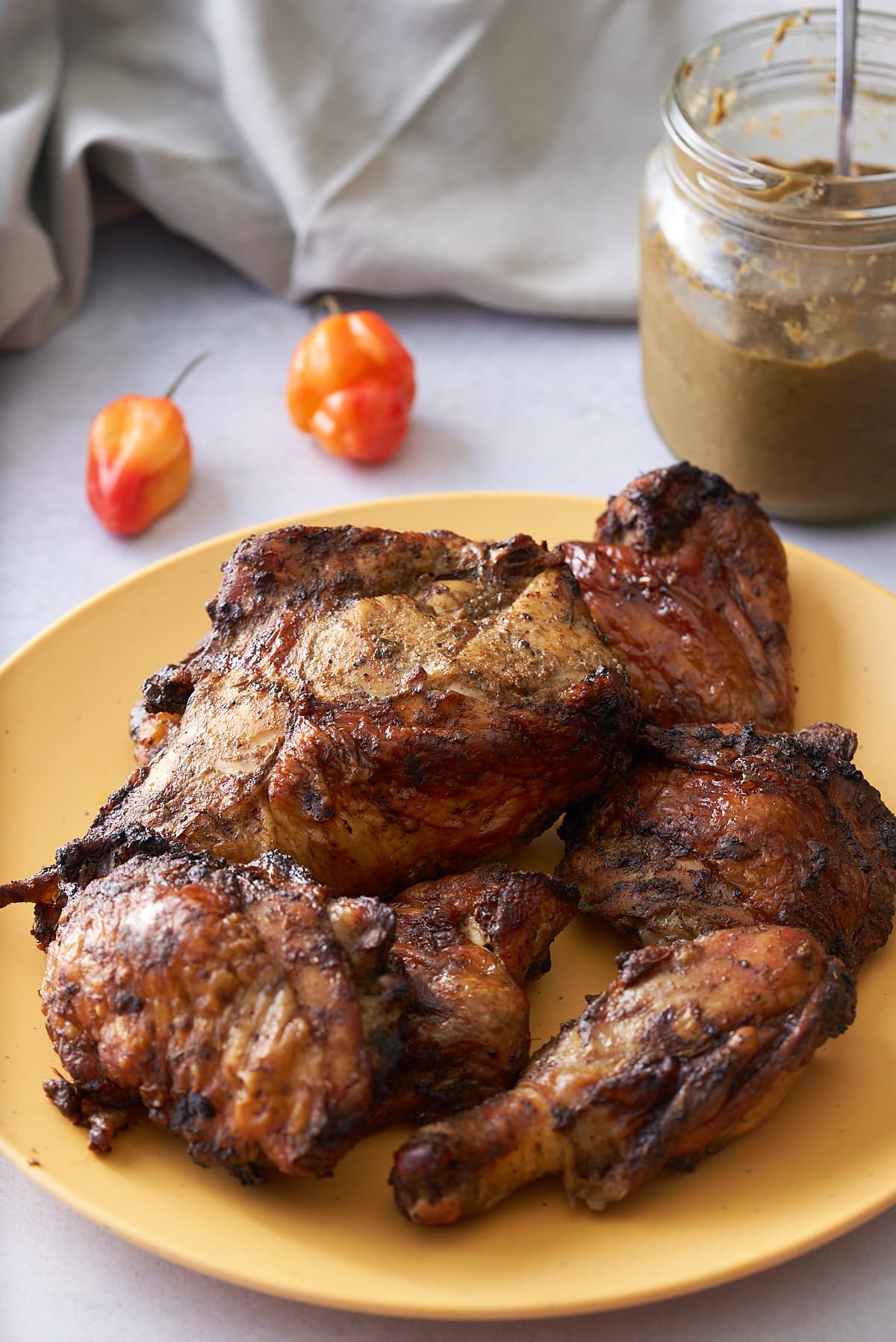 Seasoning meat with the jerk marinade.